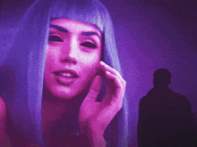 a woman with purple hair has black eyes