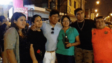 a group of people posing for a picture in front of a sign that says laisazon
