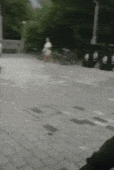 a blurry picture of a person riding a bike on a sidewalk