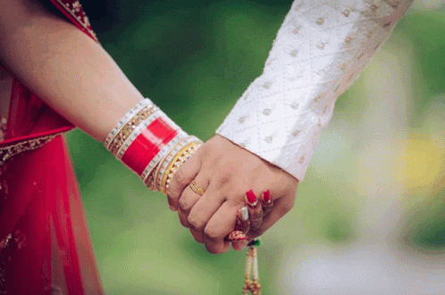 indian punjabi wedding couple holding hands