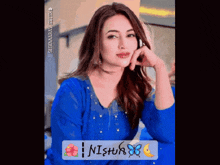 a picture of a woman in a blue dress with the name nishur on the bottom