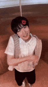 a young man with a red angry symbol on his head