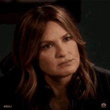 a close up of a woman 's face with the hashtag #svu on the bottom right