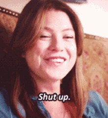 a close up of a woman 's face with the words shut up written on it