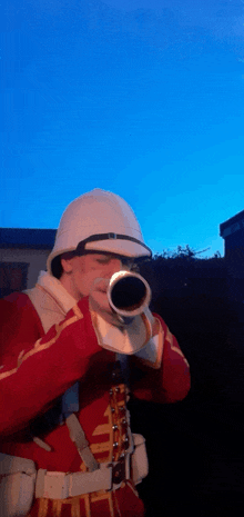 a man in a military uniform is blowing a trumpet