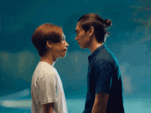 two men are looking at each other with a blue sky in the background