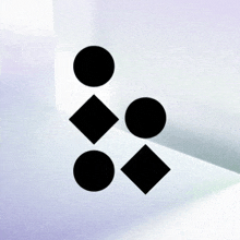 a set of black circles and squares on a white surface .