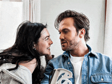 a man and a woman looking at each other