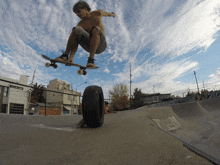 a man on a skateboard is doing a trick on a tire