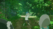 a man with a blue hat is walking down a path
