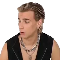 a young man wearing a black vest and a silver necklace