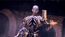 a statue of a skeleton holding a book