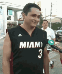 a man wearing a miami jersey with the number 3