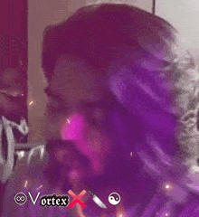 a man with purple hair and a beard has the word vortex above him