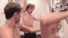a group of shirtless men are standing in front of a mirror .
