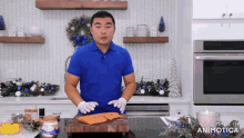 a man in a blue shirt is standing in front of a cutting board that says made in animotica on it