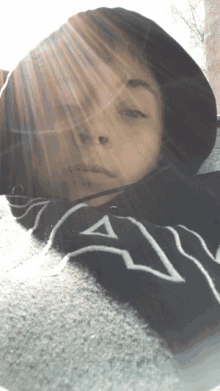 a person wearing a black and white sweatshirt with the letter a on it