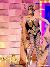 a drag queen is dancing on a stage with the words drag race all stars on the bottom