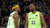 two basketball players one wearing the number 22