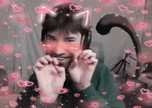 a man wearing cat ears and a cat tail is surrounded by pink hearts