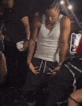 a man is dancing in a crowd of people at a party .