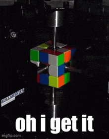 a rubik 's cube is being tested by a machine and the words oh i get it are visible