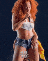 a woman with red hair is singing into a microphone with the number 10 on the bottom right