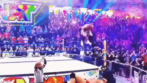 Diving elbow drop though the announcers