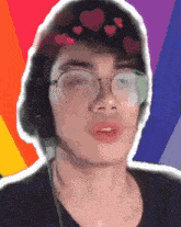 a young man wearing glasses and headphones has hearts on his head .