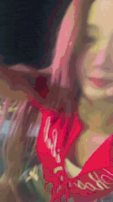 a woman with pink hair wearing a red bandana that says barbie