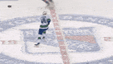a hockey player with the number 10 on his jersey is playing against another player