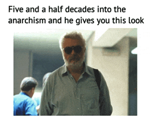 a picture of a man with a beard and sunglasses with the caption five and a half decades into the anarchism