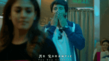 a man covering his mouth with his hands while a woman looks on and the words mr romantic are below him