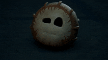 a mask with spikes on it looks like a monkey 's face