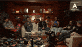 a group of people sitting around a table with a sign that says annapurna productions