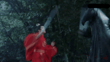 a blurry picture of a person in a red shirt holding a knife