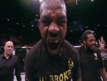 a blurred image of a man in a boxing ring with a microphone in his hand