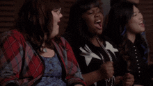 a group of women are laughing together and one of them is wearing glasses