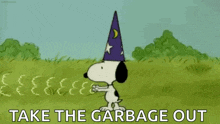 snoopy is wearing a wizard hat and standing in a field with the words `` take the garbage out '' .