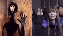 a woman in a purple jacket is standing next to a puppet with a face on it .