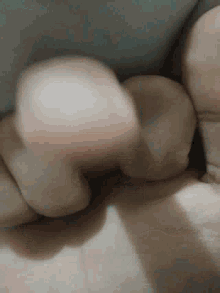 a close up of a person 's hand holding a ball .