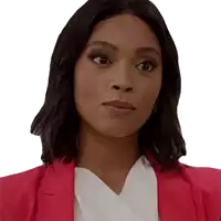 a woman wearing a pink jacket and white shirt looks at the camera
