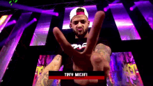 a man giving a peace sign in front of a purple background