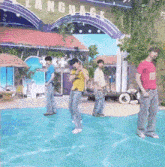 a group of men are dancing in front of a building that says language