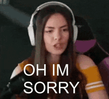 a woman wearing headphones is sitting in a chair and making a funny face .
