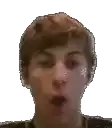 a close up of a young man making a funny face .