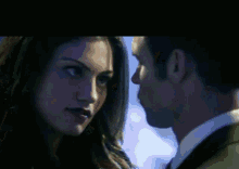 a man and a woman are looking into each others eyes