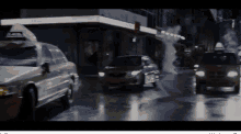a taxi cab is driving down a wet street