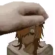 a person is putting a piece of paper on a statue of a person 's head .
