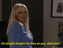 a woman in a blue sweater says " oh alright alright "